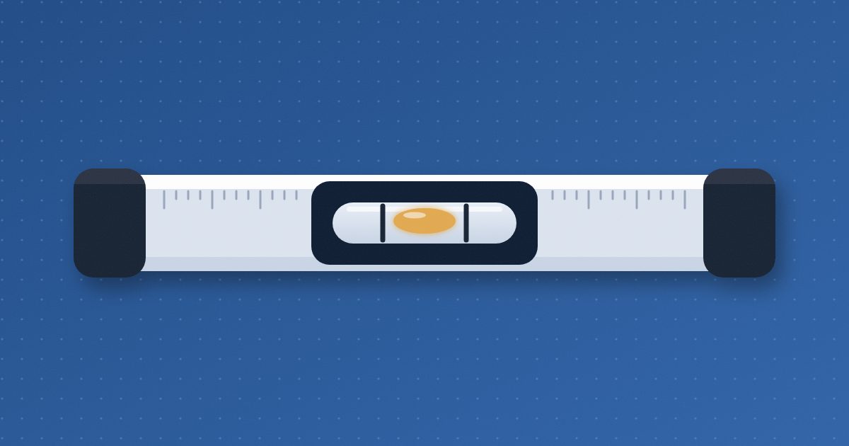 A carpenter's spirit level lies perfectly flat, its amber bubble resting exactly between the two marks of the center vial.