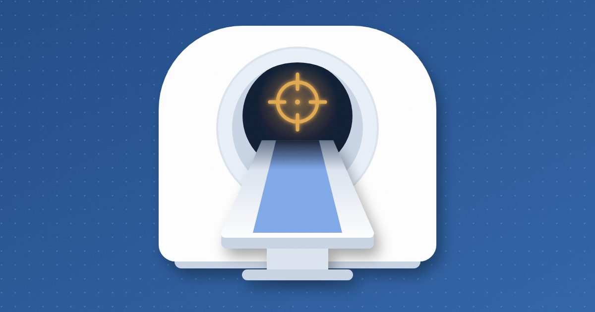 A CT scanner seen from the front, its patient table sliding into the ring, with a small amber target sight glowing inside the opening.